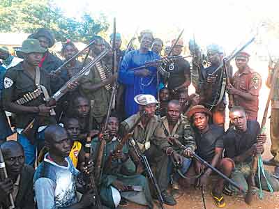 Ready for Boko Haram... Madagali hunters with their leader, Bukar Jimeta (in blue) PHOTOS: EMMANUEL ANDE