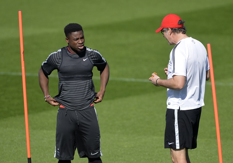 (FILES) This file photo taken on April 14, 2015 shows Paris Saint-Germain's French head coach Laurent Blanc (R) talking to Ivorian defender Serge Aurier before a training session at the Camp des Loges in Saint-Germain-en-Laye, west of Paris.  Paris Saint-Germain defender Serge Aurier could find himself in hot water after insulting manager Laurent Blanc and many of his team-mates in a live video he and a friend recorded with the online app Periscope late on February 13, 2016. The Ivorian at one stage appeared to describe Blanc as a "faggot", although he was not actually in shot at the time.  / AFP / MIGUEL MEDINA