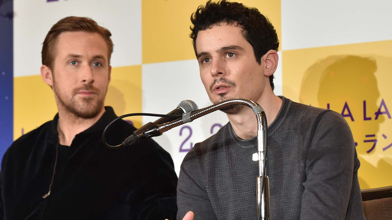 US film director Damien Chazelle (R) answers questions as Canadian actor Ryan Gosling (L) looks on during a press conference for their film "La La Land" in Tokyo on January 27, 2017. Romantic showbiz musical "La La Land" topped the Oscars nominations list on January 25 with a whopping 14 nods, tying an all-time record. KAZUHIRO NOGI / AFP