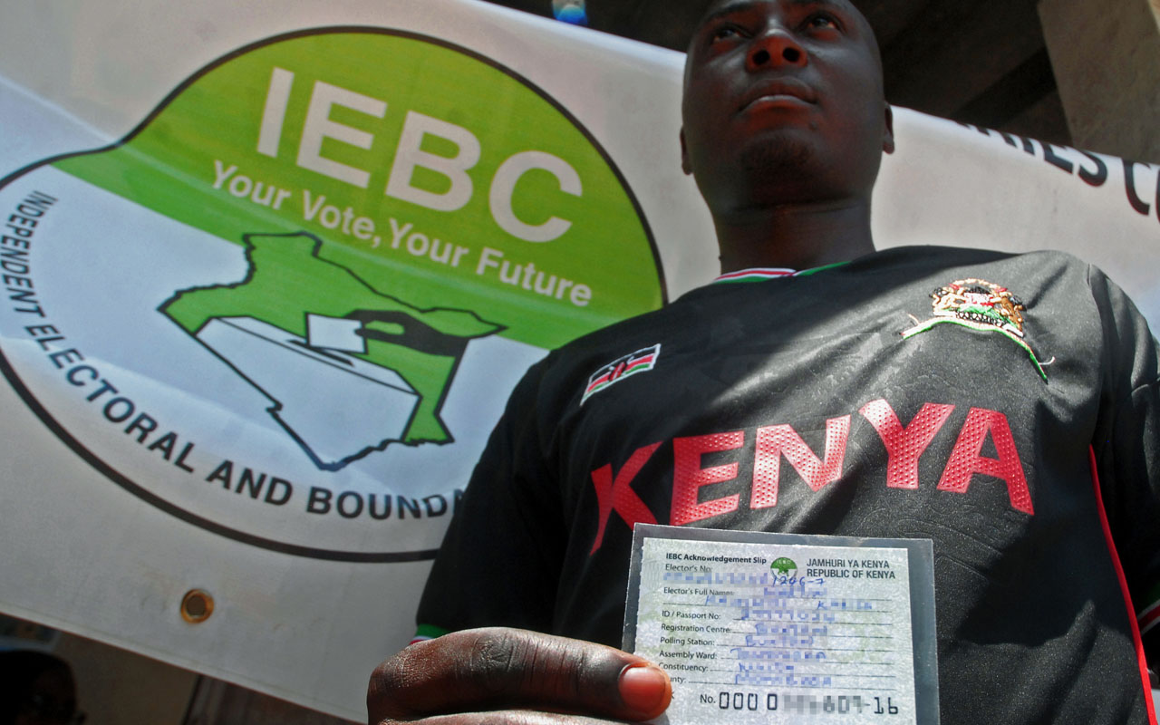 A potential voter holds his card after undergoing the voter registration process at the start of countrywide 14-day exercise at the Kenyan port city of Mombasa on January 16, 2017. Kenya's election commission on January 16 began a drive to register millions of new voters ahead of August elections, with rival parties going all out to get their supporters to sign up. Authorities estimate that some four to six million people have yet to register, crucial numbers that could swing the result. / AFP PHOTO / ANDREW KASUKU