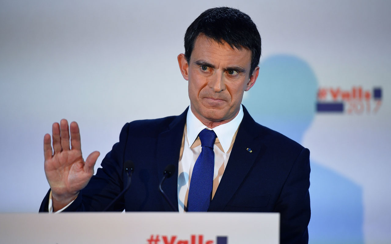 Former prime minister and candidate for the left-wing primaries, Manuel Valls gestures before speaking following the first round of the left-wing primary for the 2017 French presidential election, on January 22, 2017 at the Latin American House in Paris. Outsider Benoit Hamon came first in the French Socialists' presidential primary on January 22, 2017 and will stand against former prime minister Manuel Valls in a January 29 runoff, partial results showed. With just over one-third of polling stations reporting, Hamon scored 35.21 percent to 31.56 percent for Valls, with former economy minister Arnaud Montebourg eliminated along with four other candidates, party electoral official Thomas Clay announced. / AFP PHOTO / Eric FEFERBERG