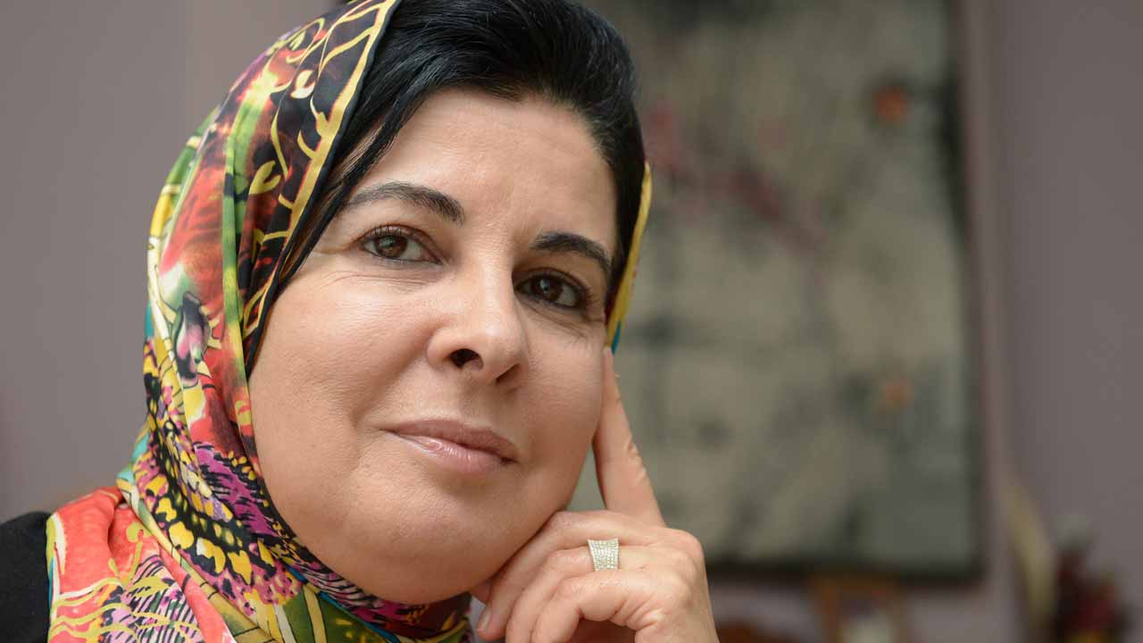 A photo taken on October 26, 2013 shows Moroccan doctor Asma Lamrabet posing at her home in Rabat. Lamrabet is used to multi-tasking -- mixing her writing with a career in medicine -- but perhaps her most noteworthy balancing act is being both a faithful Muslim and a committed feminist. FADEL SENNA / AFP