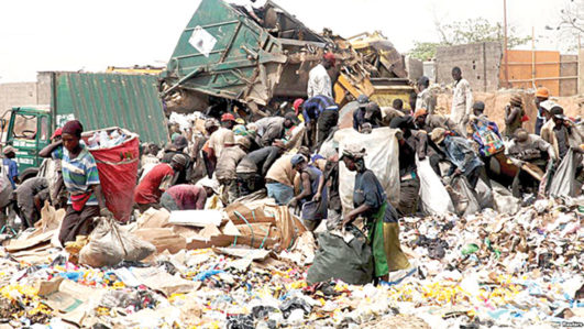 [FILES] Scavengers picking up trash for recycling at a dump site