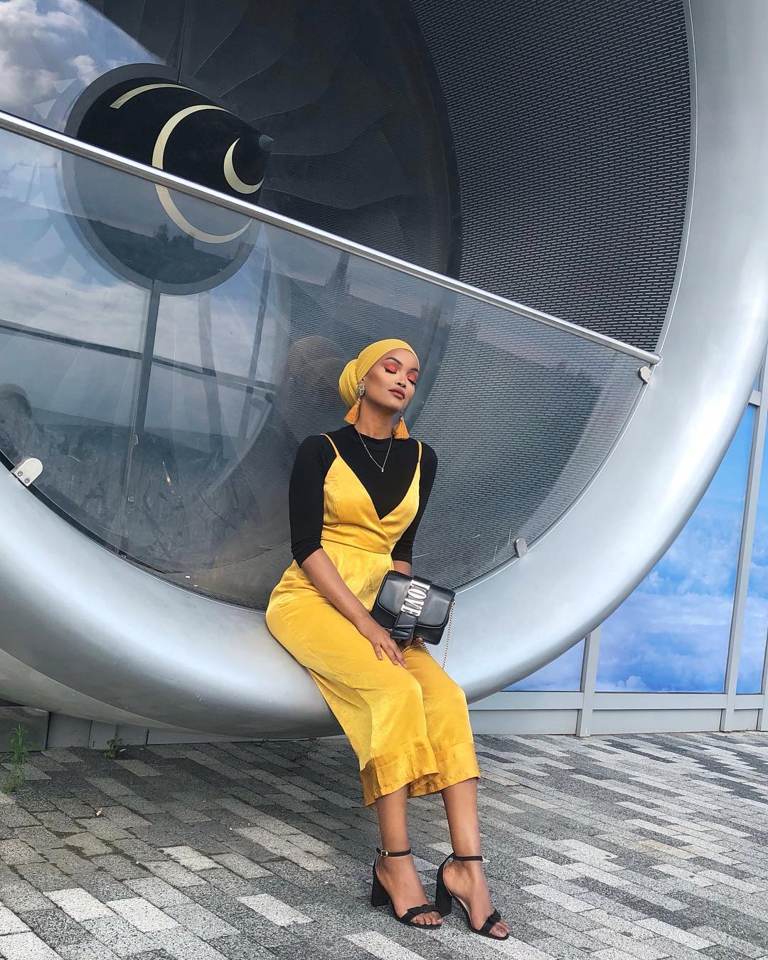 Jawahir Khalifa in a mustard Missguided Jumpsuit layered over a black