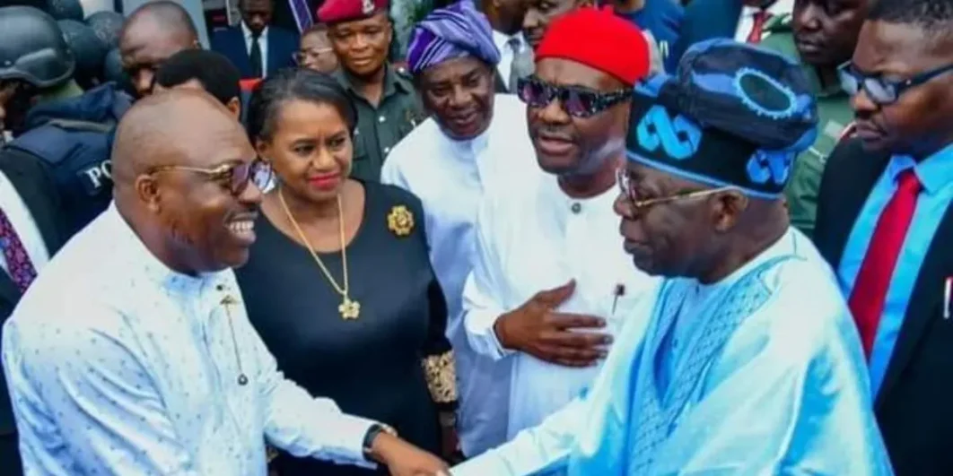 President Bola Tinubu and Siminalayi Fubara shake hands