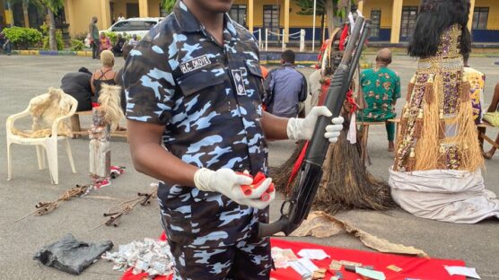 Imo State Police Command spokesman, ASP Henry Okoye, displaying some of the items recovered from some arrested suspected kidnapper during their parade at the Command's headquarters in Owerri, weekend