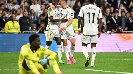 Real Madrid's Turkish midfielder #24 Arda Guler celebrates with Real Madrid's Brazilian forward #07 Vinicius Junior