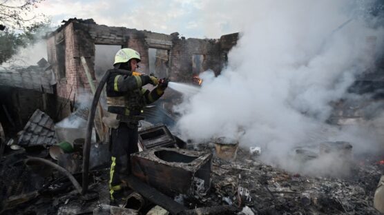 Firefighters put out a fire in a private house after a Russian drone attack in the suburbs of Kharkiv, on May 21, 2024, amid the Russian invasion in Ukraine. (Photo by SERGEY BOBOK / AFP)