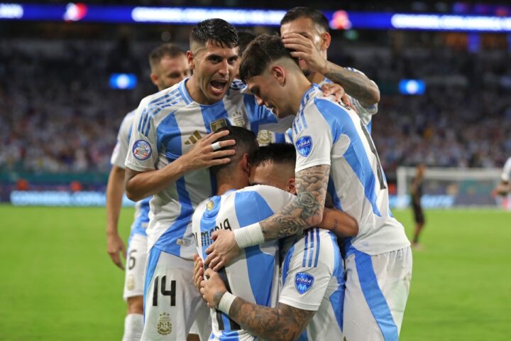 Argentina's forward #22 Lautaro Martinez (C) celebrates scoring his team's first goal with teammates during the Conmebol 2024 Copa America tournament group A football match between Argentina and Peru at Hard Rock Stadium in Miami, Florida on June 29, 2024. (Photo by Chris ARJOON / AFP)