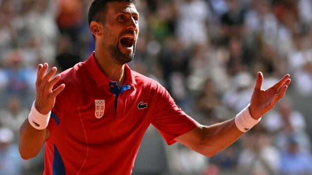 Serbia's Novak Djokovic reacts to beating Spain's Carlos Alcaraz in their men's singles final tennis match on Court Philippe-Chatrier at the Roland-Garros Stadium during the Paris 2024 Olympic Games, in Paris on August 4, 2024. (Photo by PATRICIA DE MELO MOREIRA / AFP)