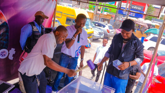 Dr Charles Akhenamen of Big Shot Lottery calling winners of SureShot Daily N100,000 draws at an activation over the weekend.jpeg