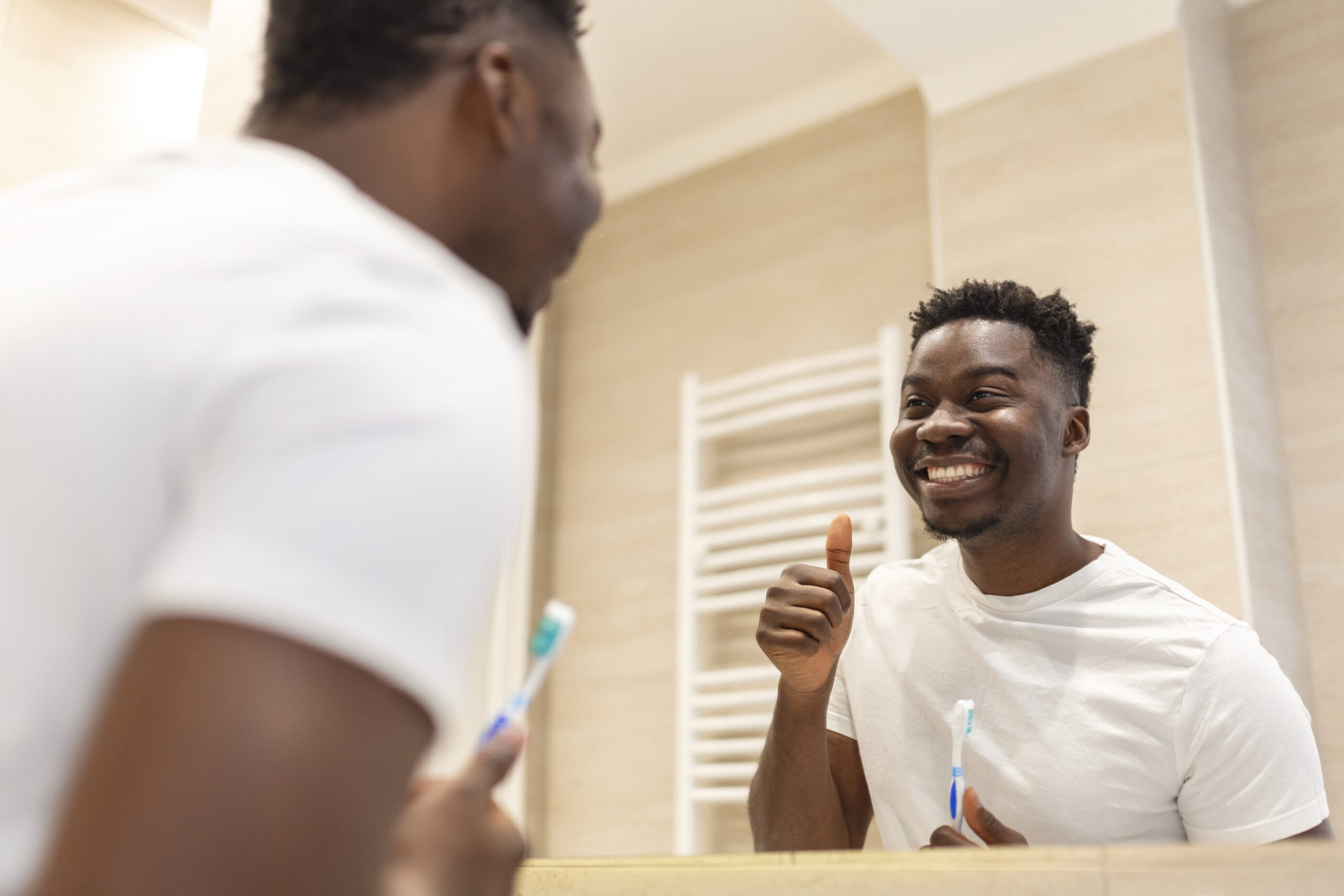 Man smiling at a mirror