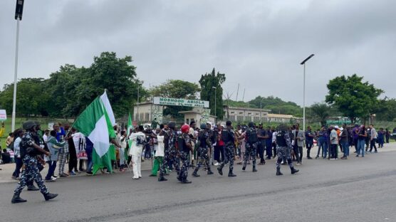 The number of security forces at the National Stadium in Abuja with combined 20 Toyota Hilux and three ambulances is competing with the number of protesters