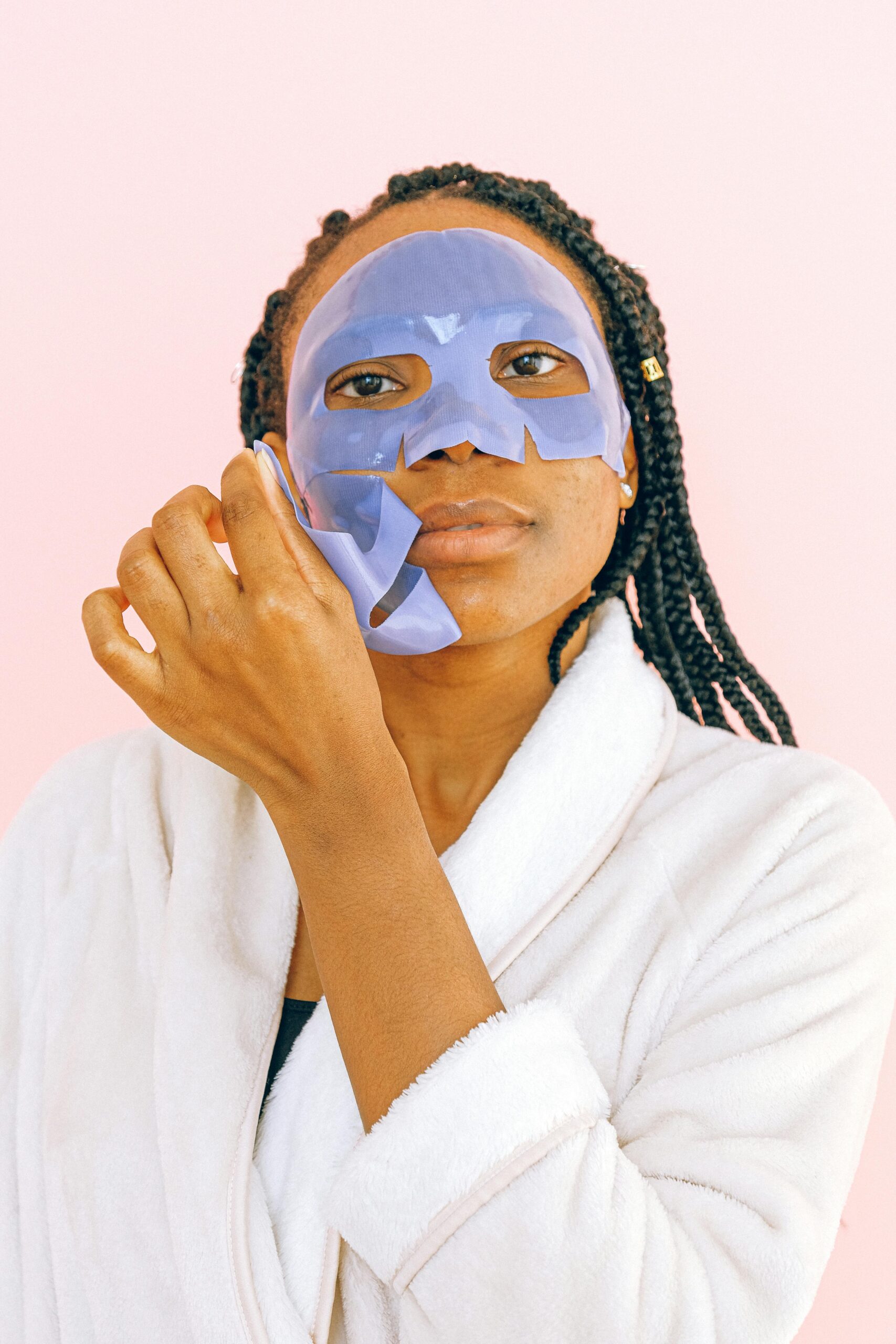 Lady peeling off sheet mask from her face