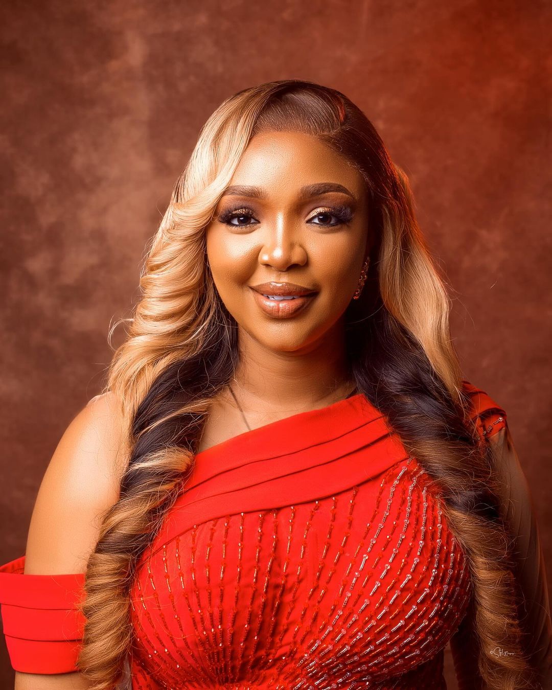 Ekene Umenwa on a red dress and blonde hair