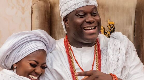 Ooni of Ife and wife Olori Ashley sitting and smiling