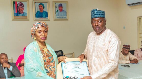 The Kaduna State Independent Election Commission (KAD-SIECOM) Chairman, Hajia Hajara Mohammed, presents Certificate of Return to one of the 23 new LG chairmen