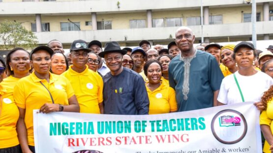 Representative of Rivers State Governor and Head of State Civil Service, Dr George Nwaeke (left); receiving an address from State Chairman of Nigeria Union of Teachers (NUT), Comrade Collins Echikpu (right); during a thank you visit by leaders and delegation of members of the NUT to Government House in Port Harcourt on Wednesday