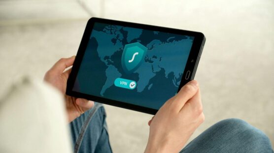 A VPN app on a tablet with a hand holding it.