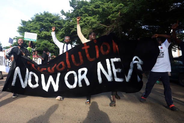 Protesters carry a large banner reading "Revolution now or never" during the "Fearless In October" protest over bad governance in Abuja, Nigeria on October 1, 2024.