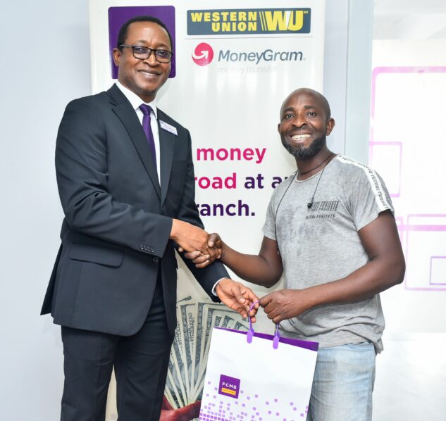 Mr. Emmanuel Comla, National Head of Sales, First City Monument Bank (FCMB), connected with customers and showed appreciation for their support. At the bank's Gbagada branch in Lagos, he is pictured with a customer, Mr Oluwasegun Banjoko.