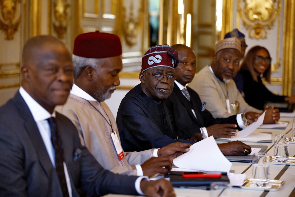 Nigerian president Bola Tinubu (C) and his delegation attend a meeting with French President at the Elysee palace in Paris, on November 28, 2024. (Photo by Sarah Meyssonnier / POOL / AFP)