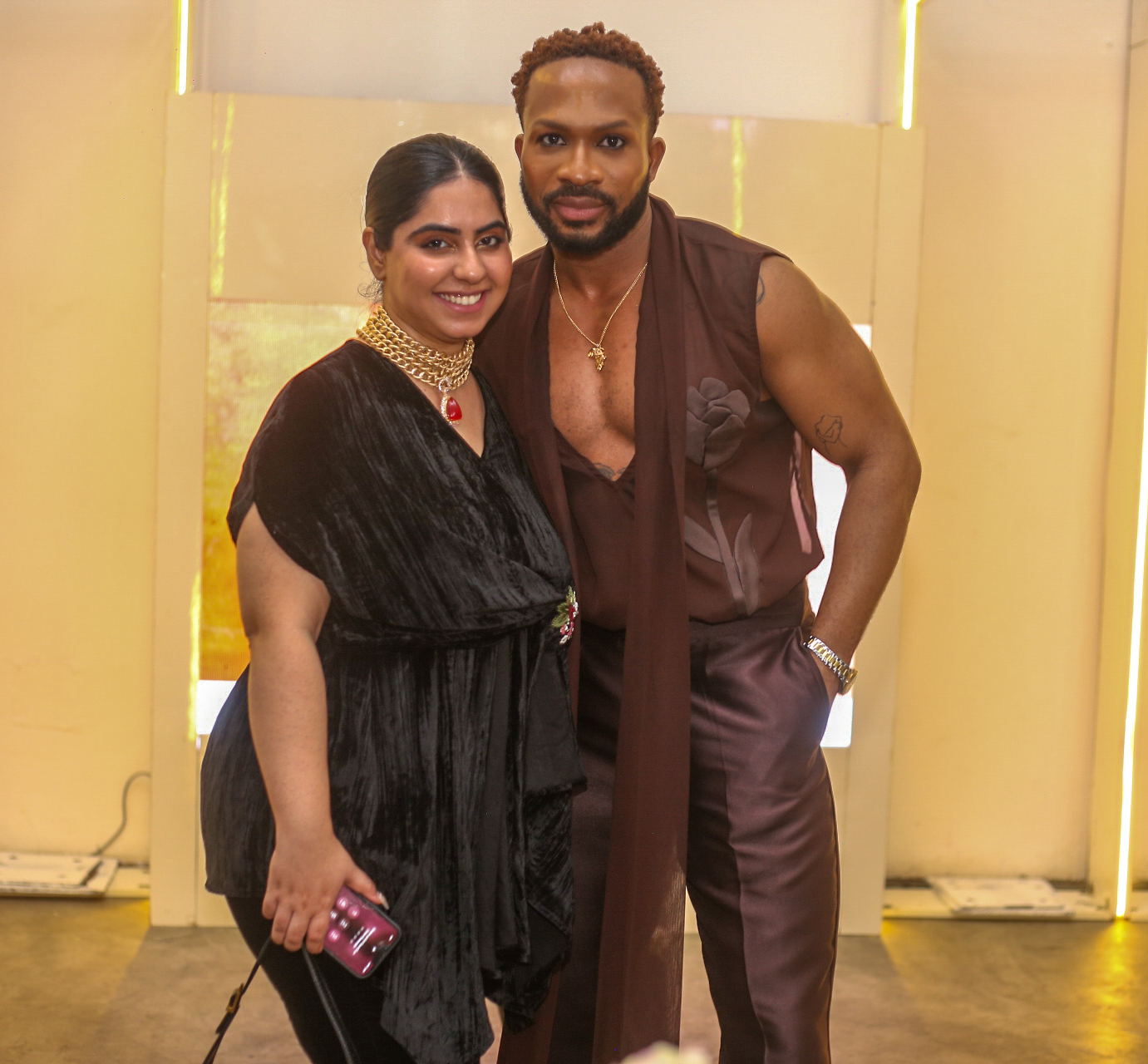 Adebayo Oke-Lawal and a lady on black outfit with a gold necklace