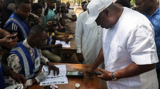 Former Ghana President and presidential candidate of the National Democratic Congress (NDC) party John Mahama registers his biometrics at a polling station in Bole on December 7, 2024 during the Ghana presidential and parliamentary elections. (Photo by Nipah Dennis / AFP)