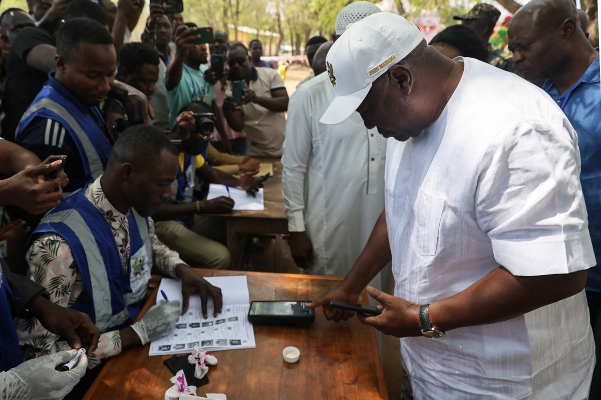 Former Ghana President and presidential candidate of the National Democratic Congress (NDC) party John Mahama registers his biometrics at a polling station in Bole on December 7, 2024 during the Ghana presidential and parliamentary elections. (Photo by Nipah Dennis / AFP)