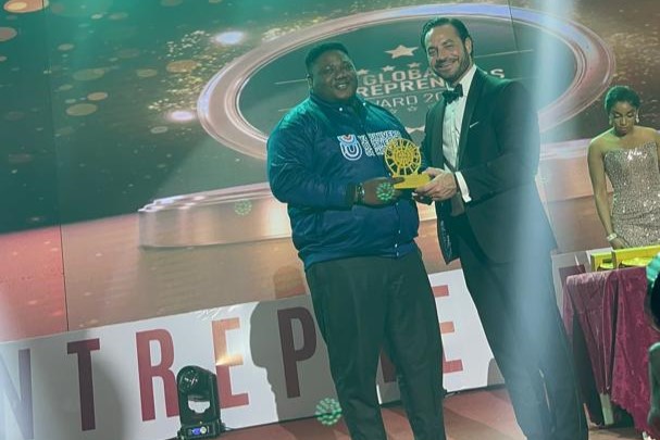 Michael Egbekoya, GMD of McYouniverse Group, receives the Young Entrepreneur of the Year Award at the Global Entrepreneurship Festival in Akure, recognising his innovative contributions to business and development.