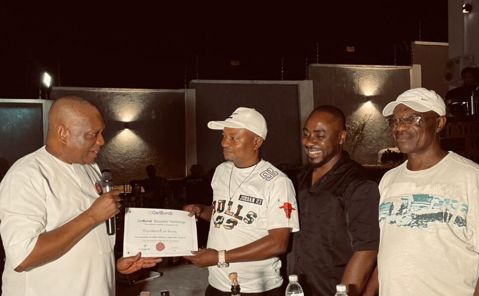 Senator Orji Kalu presents certificates to 12 Abia youths who completed the Digital Skill Youth Empowerment Programme sponsored by Chief Sam Okorie, highlighting the transformative power of technology education.