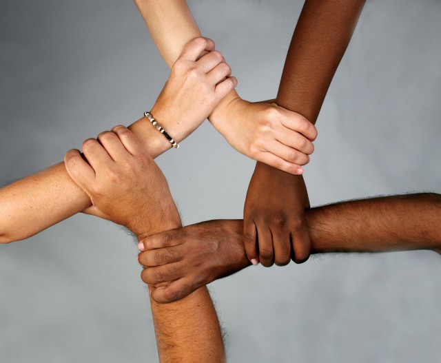 different cultures around the world holding hands